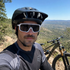 Mountain biker wearing White ApexShift clear-to-dark cycling glasses